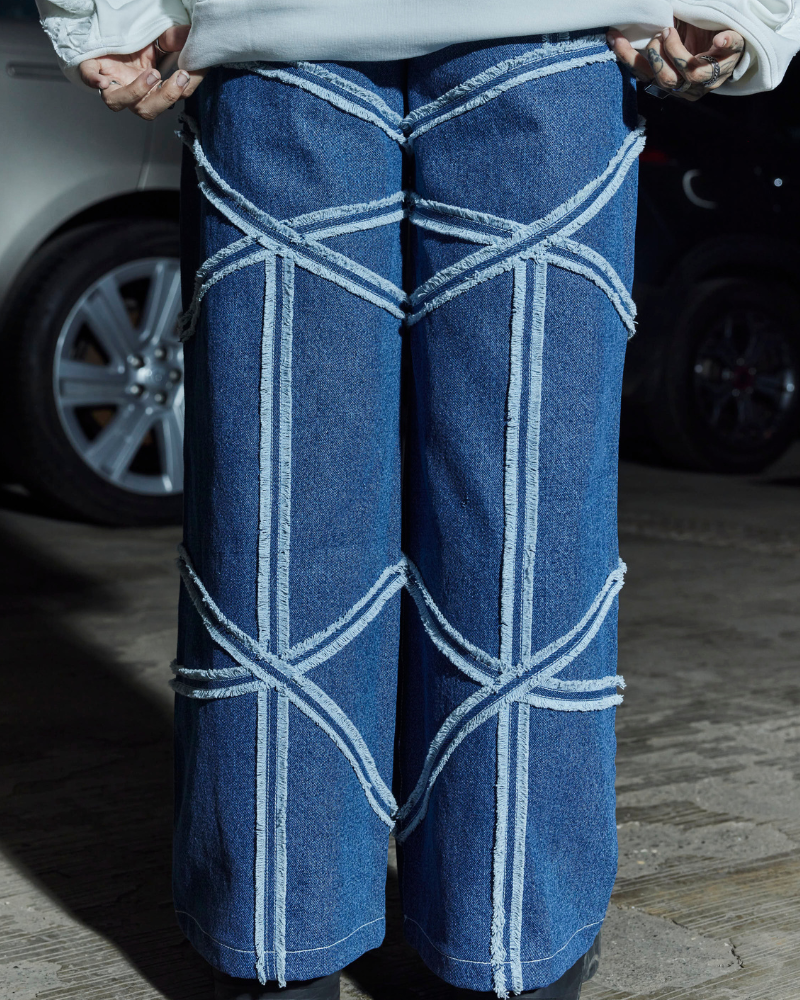 Back view of female model in Criss oversized denim pants – Volfsbane streetwear for women

