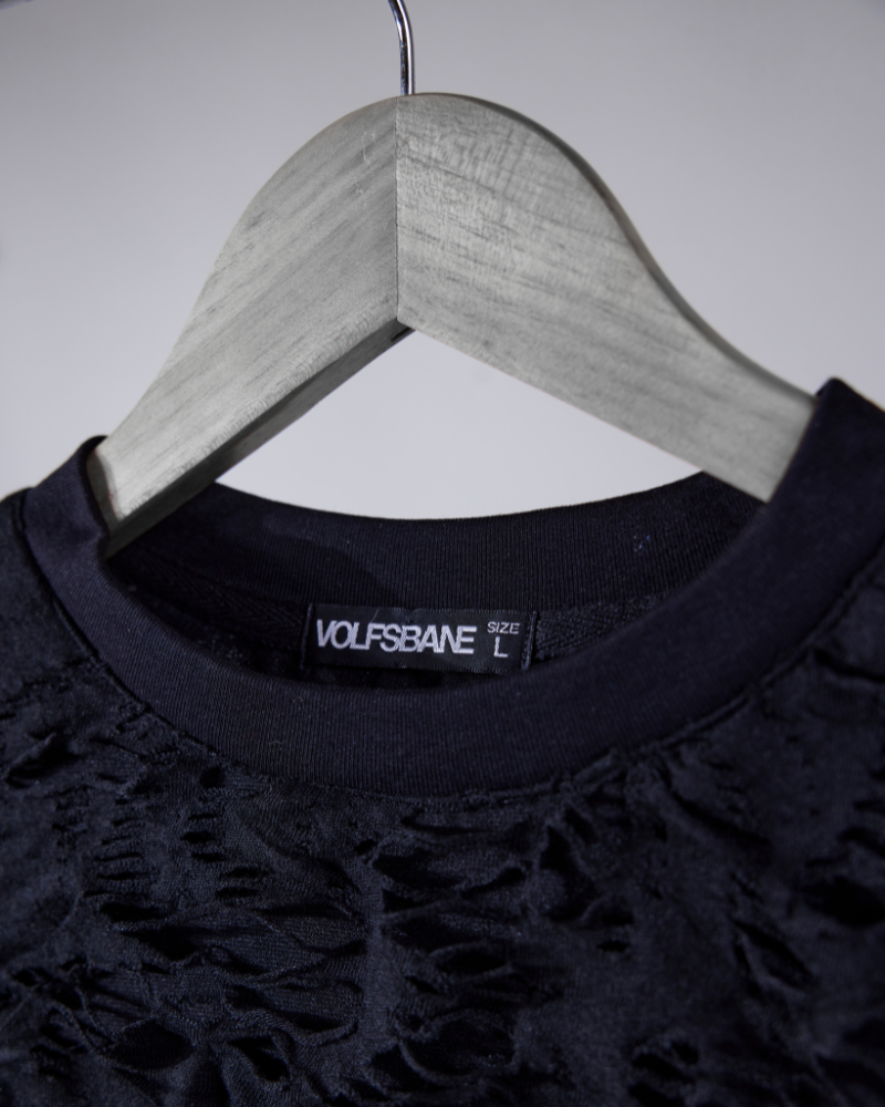 Close-up of raw ripped fabric texture on Torn oversized T-shirt – Volfsbane streetwear
