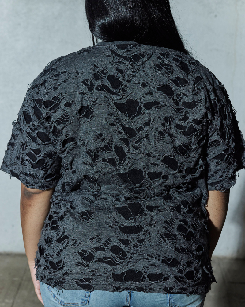 Back view of grey Torn oversized T-shirt worn by female model – Volfsbane streetwear India
